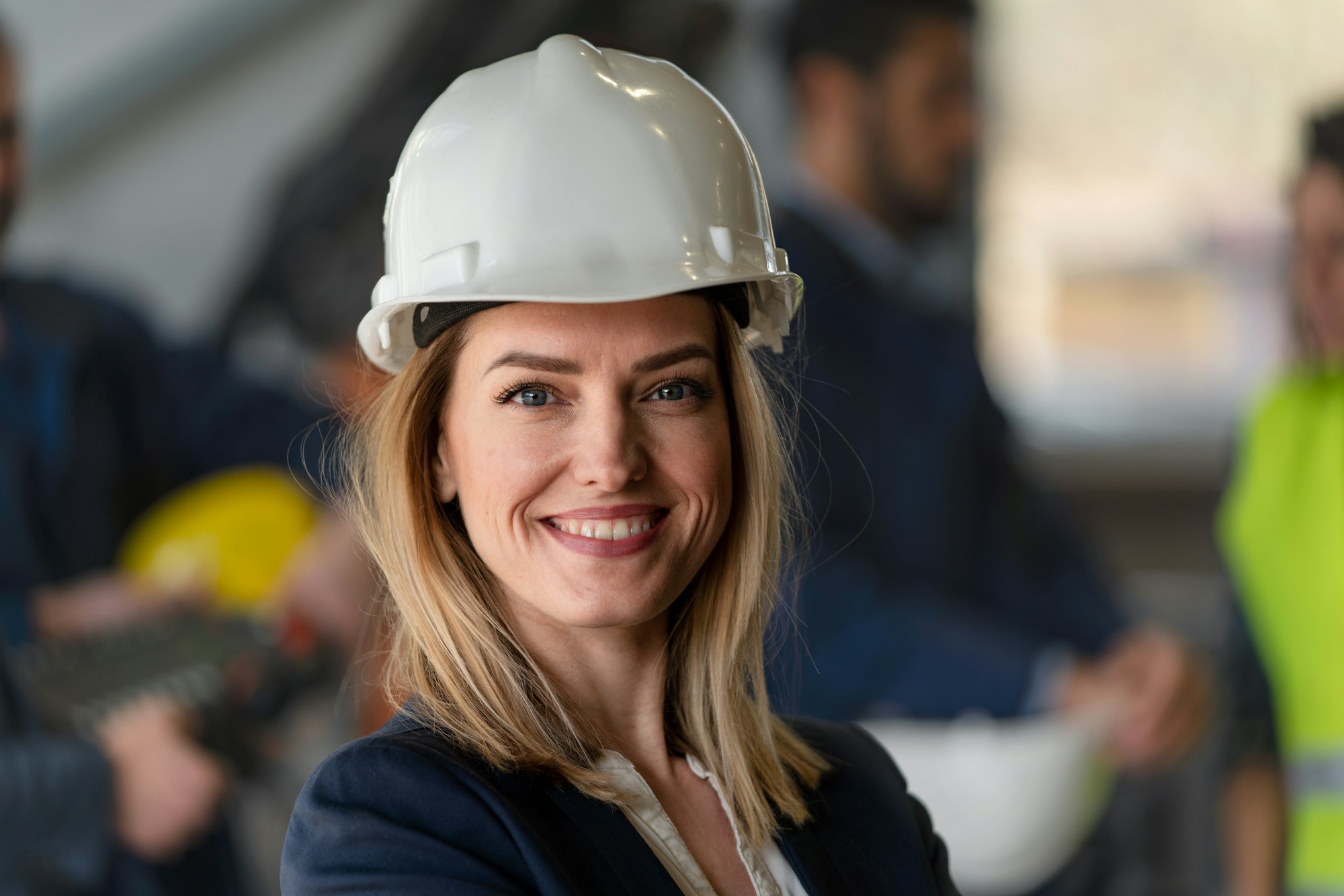 Portrait of female chief engineer in modern industrial factory looking at camera.